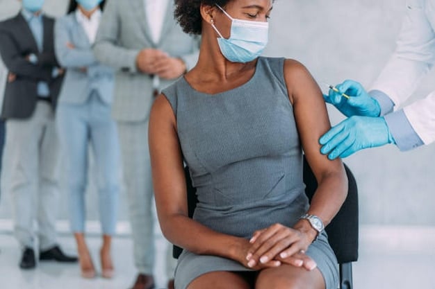 A healthcare worker administering a flu shot to an adult in a clinical setting, subtly conveying safety and prevention.