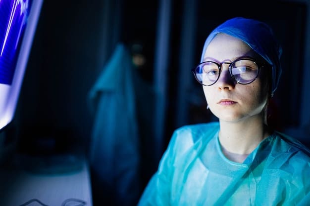 A night shift worker in a medical setting, wearing blue light blocking glasses, looking at a patient chart on a tablet. The background shows fluorescent lighting and minimal external light, emphasizing the indoor environment.