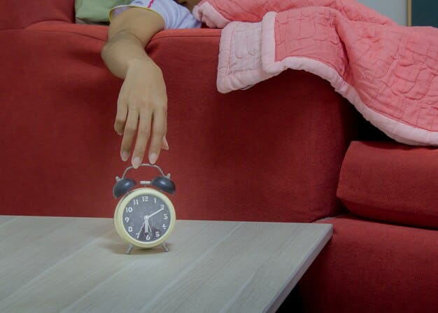 An alarm clock showing an early morning time, placed on a bedside table next to blue light blocking glasses, signifying the end of a night shift and preparation for sleep. The background is dimly lit by blackout curtains.