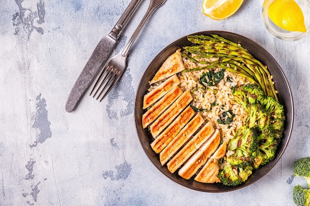 An overhead shot of a healthy, balanced anti-inflammatory meal on a plate, featuring grilled salmon, roasted broccoli, and a side of quinoa.