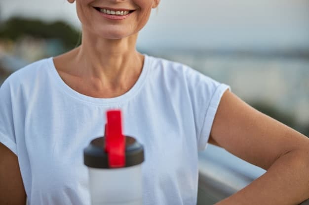 A close-up of an athlete rehydrating with a large water bottle after an intense session, beads of sweat visible, symbolizing post-workout recovery.