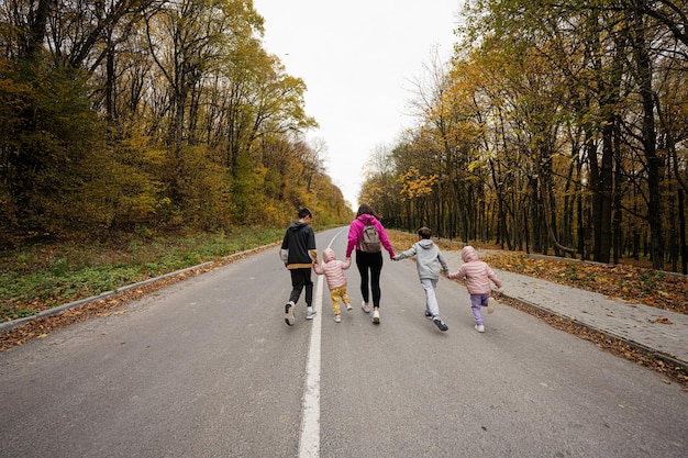 A diverse group of people engaging in outdoor activities like walking and cycling in a brightly lit park during autumn, emphasizing natural light exposure.