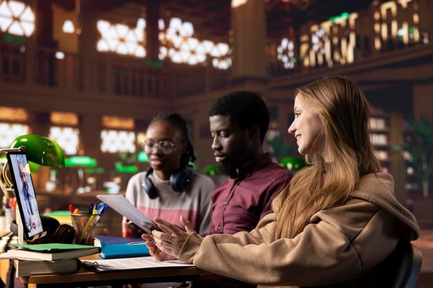 A diverse group of students collaborate on a project in a modern library setting, all using laptops or tablets to access digital resources. Bright, natural lighting illuminates the scene.