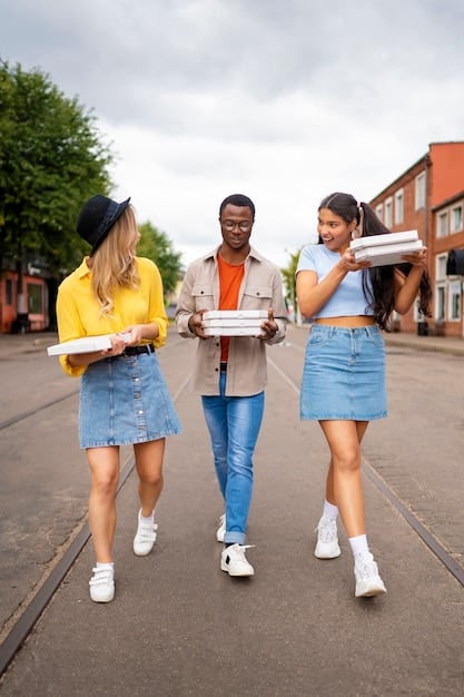 A diverse group of college students smiling and walking on a university campus, carrying books and backpacks, symbolizing the beneficiaries of educational financial aid.