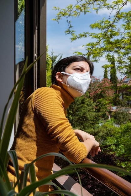 A person wearing a face mask while gardening in a sunlit backyard, showing practical steps to reduce pollen exposure during outdoor activities.