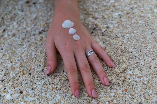 A close-up shot of a hand applying mineral sunscreen, showing its texture and how it blends into the skin.