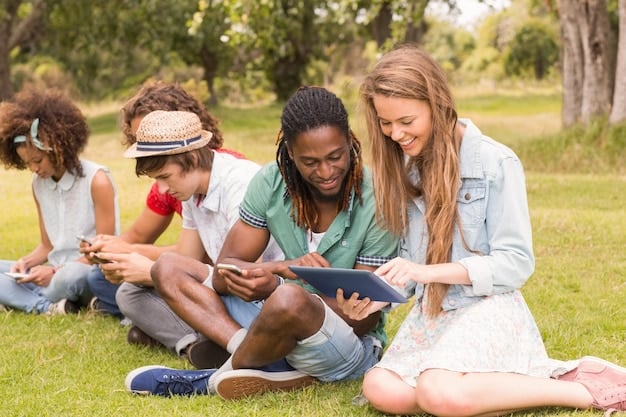 A diverse group of students collaborating and studying with open laptops and tablets, surrounded by natural light, symbolizing modern, collaborative learning methods.
