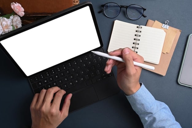 A person's hand holding a pen, making notes on a pad next to a laptop displaying graphs and charts, symbolizing financial planning and assessment of educational investments. The background is a blurred office environment.
