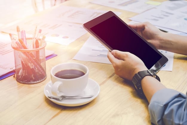 A person's hands filling out a FAFSA form on a tablet, with a calculator and coffee cup on a desk, emphasizing thoughtful financial planning.
